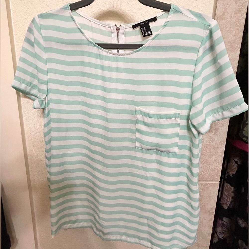 Chiffon blouse with front pocket and cute functional zipper in the back.